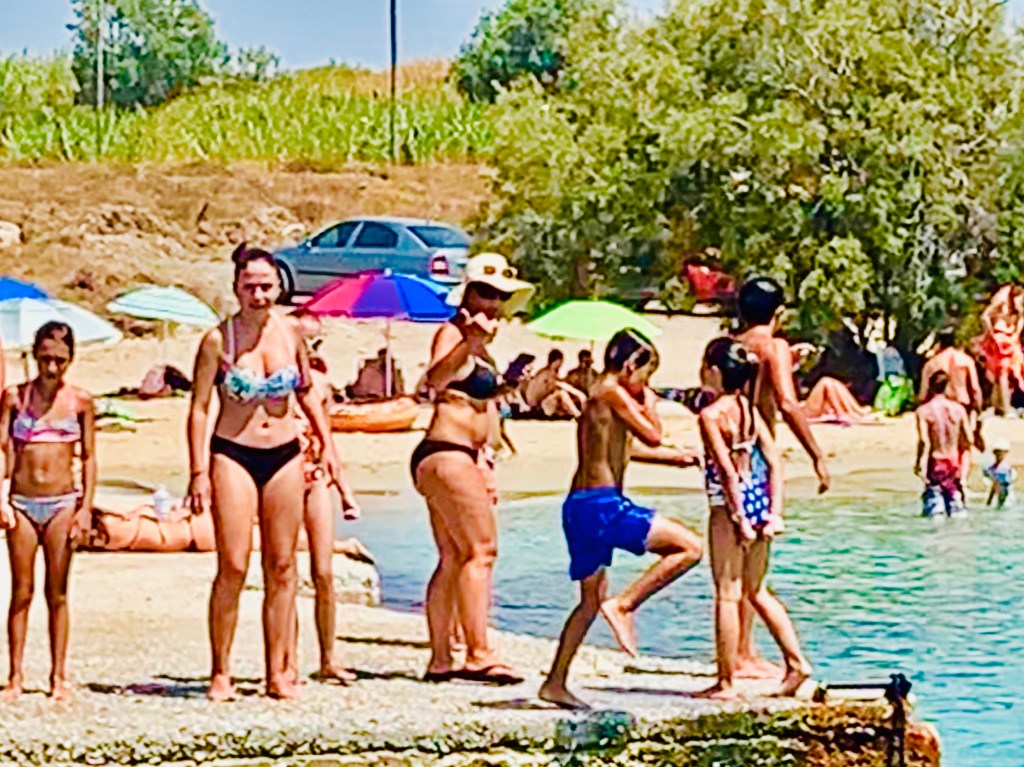 Children jumping into sea