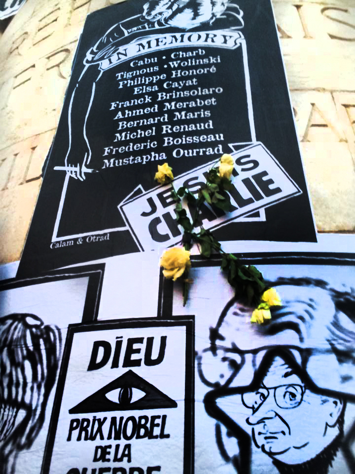 Je Suis Charlie  signs and flowers on the Marian